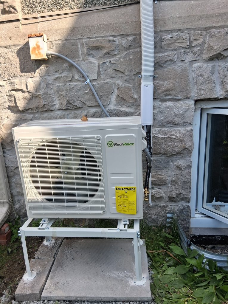 Newly installed outdoor condenser unit on concrete pads